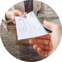 Woman Giving Cheque To Her Colleague At Workplace In Office