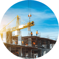 Construction site with cranes and building with blue sky background